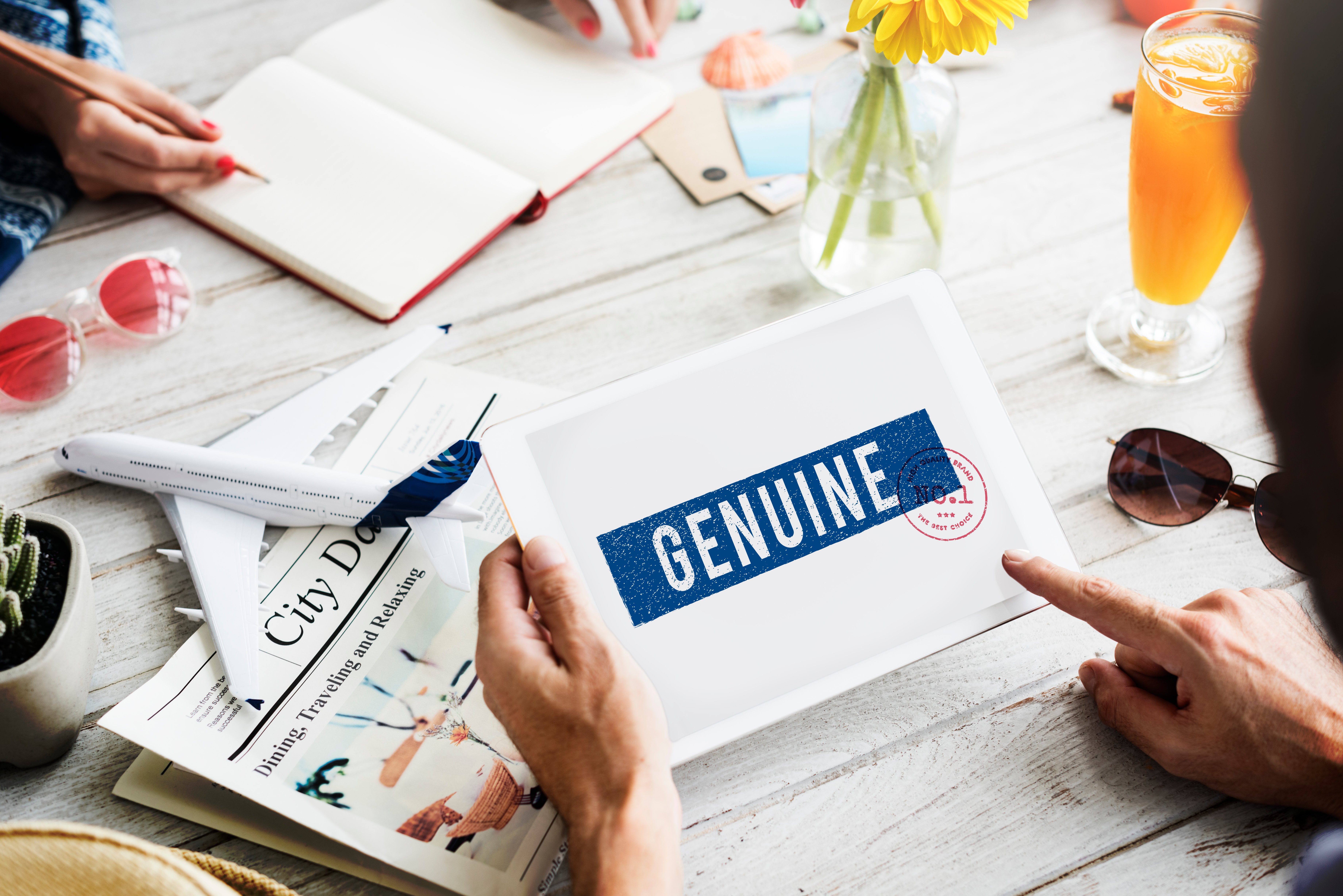 Person holding an envelope that says, "Genuine" 